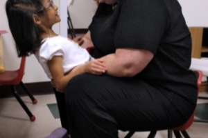 Carla picks up her youngest daughter, Caroline, during the pre-school service at their church.