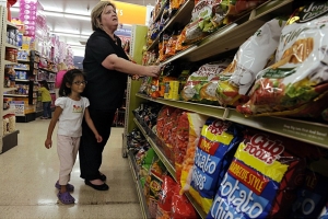 Carla and Caroline rummage through the snack aisle at Big Lots for a corn-syrup free snack food.  Due to the way she was fed in the orphanage in China Caroline has a very sensitive stomach and has developed allergies over time, corn is one of the more difficult allergies for the family to accomadate.