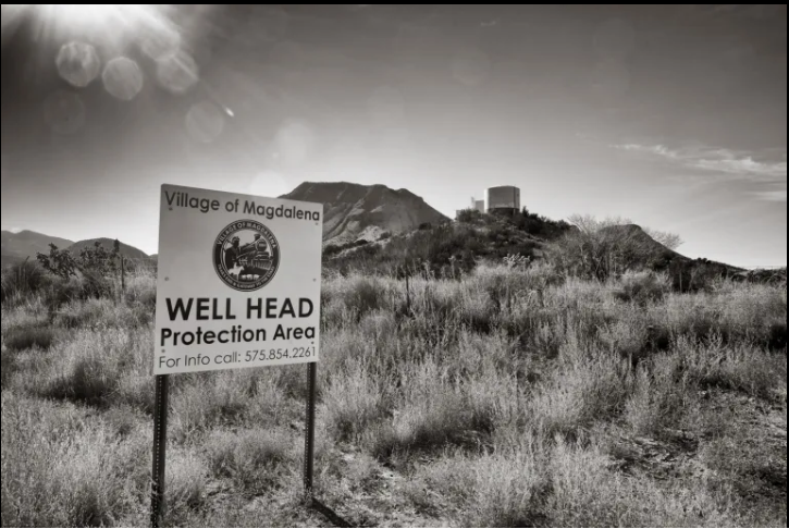 Water storage tanks stand on a hill overlooking Magdalena.